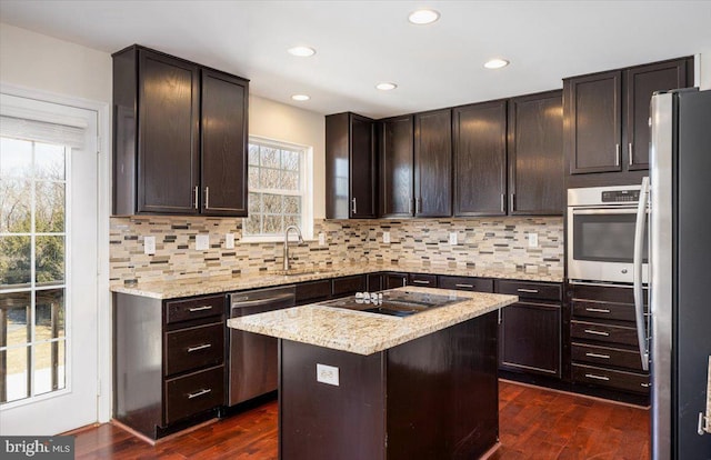 kitchen with stainless steel appliances, dark wood-type flooring, and tasteful backsplash