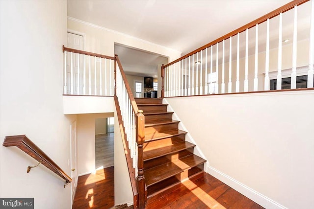 stairs with baseboards and wood finished floors