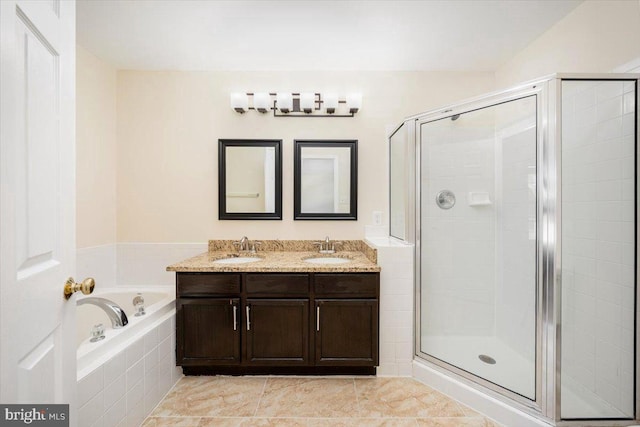 bathroom with a sink, a shower stall, and a bath