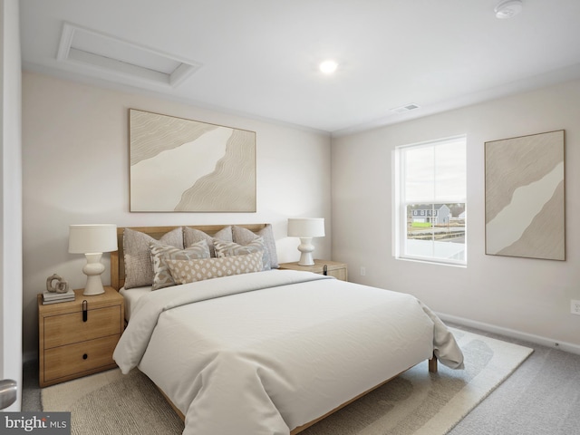 carpeted bedroom featuring attic access, visible vents, and baseboards