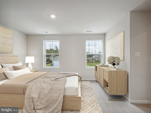 bedroom featuring light carpet, multiple windows, and visible vents