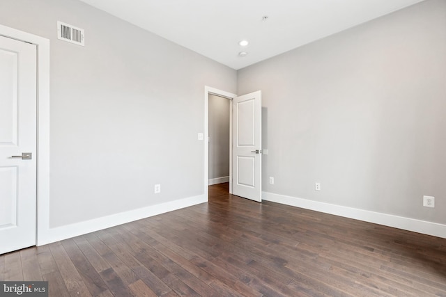 unfurnished room featuring baseboards, visible vents, dark wood-type flooring, and recessed lighting