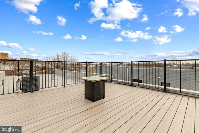 wooden deck featuring cooling unit