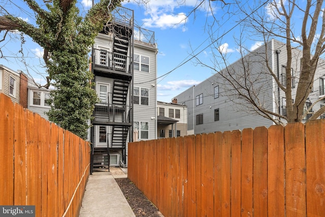 exterior space featuring fence private yard and a balcony