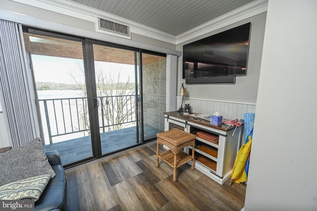 home office featuring wainscoting, visible vents, crown molding, and wood finished floors