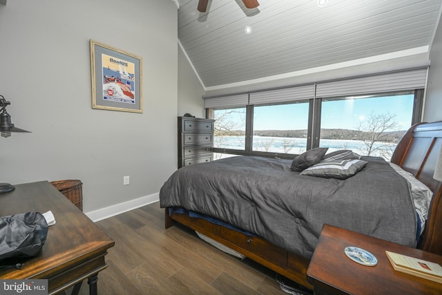 bedroom with vaulted ceiling, ceiling fan, wood finished floors, and baseboards