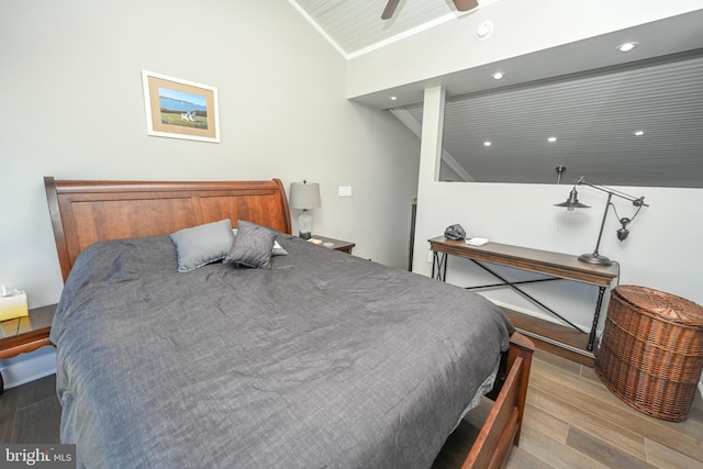 bedroom with a ceiling fan, recessed lighting, vaulted ceiling, and wood finished floors