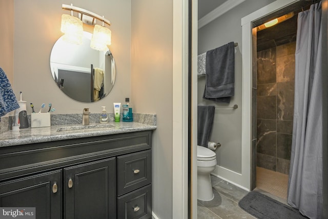 bathroom with baseboards, tiled shower, toilet, crown molding, and vanity