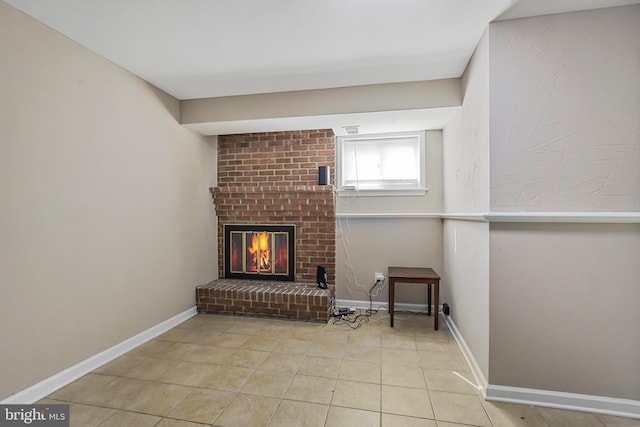 tiled living room with a brick fireplace and baseboards