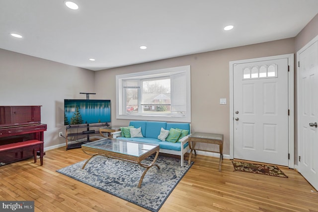 living area with recessed lighting, wood-type flooring, and baseboards