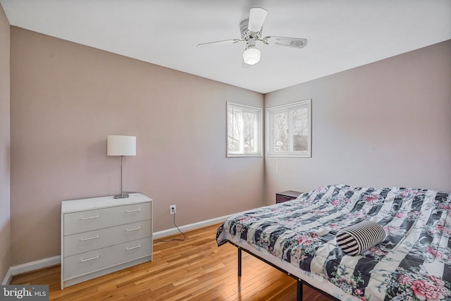 bedroom featuring light wood-style floors, ceiling fan, and baseboards