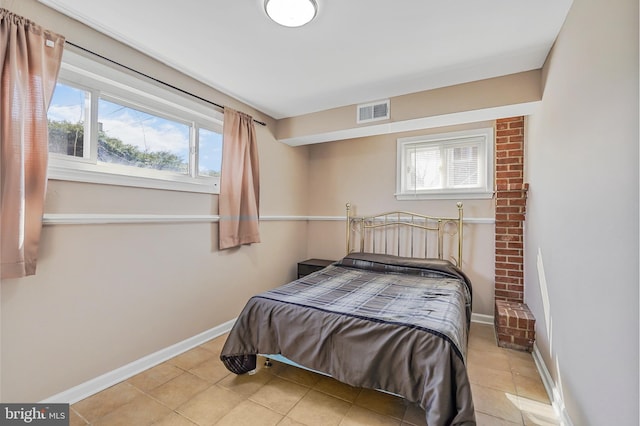 bedroom featuring visible vents, baseboards, and light tile patterned flooring