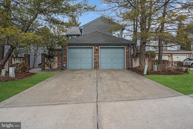 traditional home featuring a garage, concrete driveway, brick siding, and roof with shingles