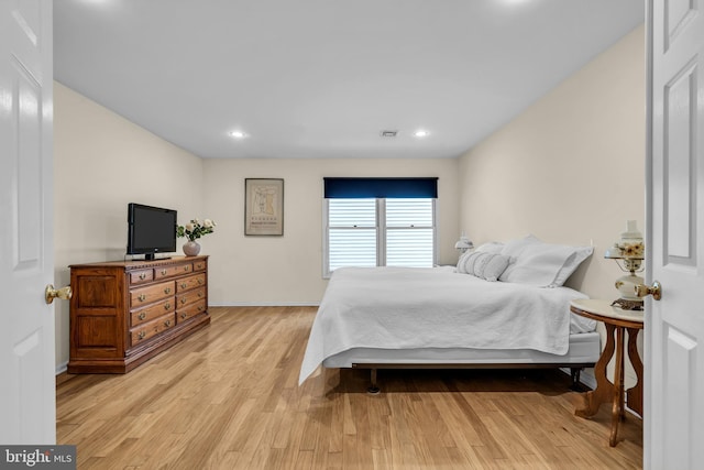 bedroom with baseboards, recessed lighting, visible vents, and light wood-style floors