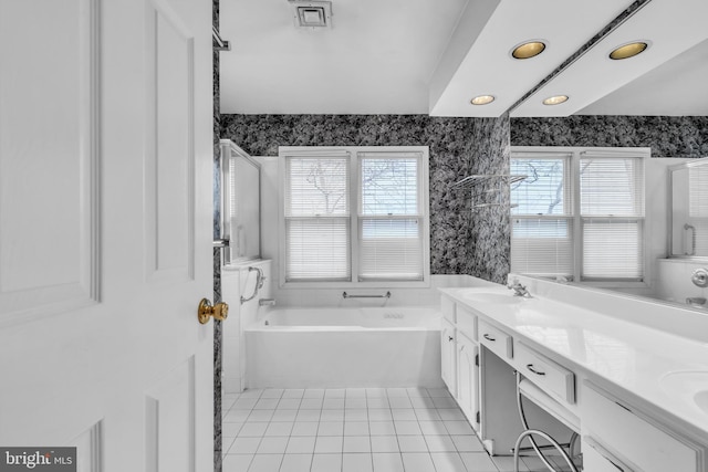 full bath with a garden tub, a sink, tile patterned floors, double vanity, and wallpapered walls