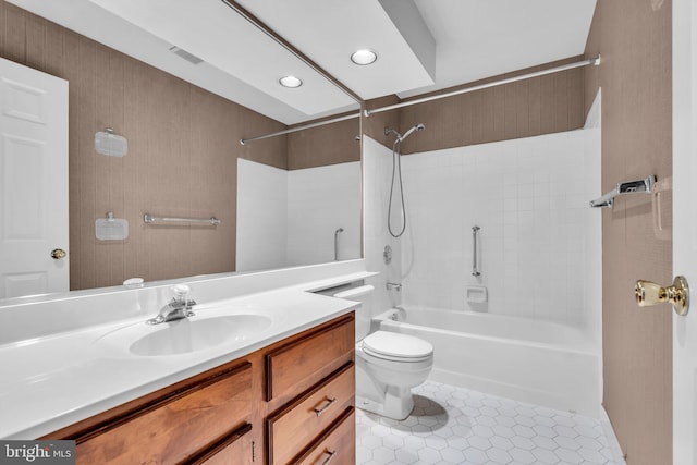 full bath featuring toilet, vanity, visible vents, tile patterned floors, and washtub / shower combination