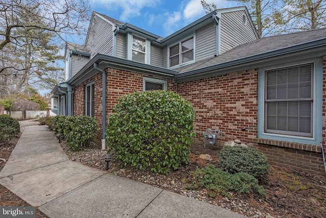 view of side of home featuring brick siding