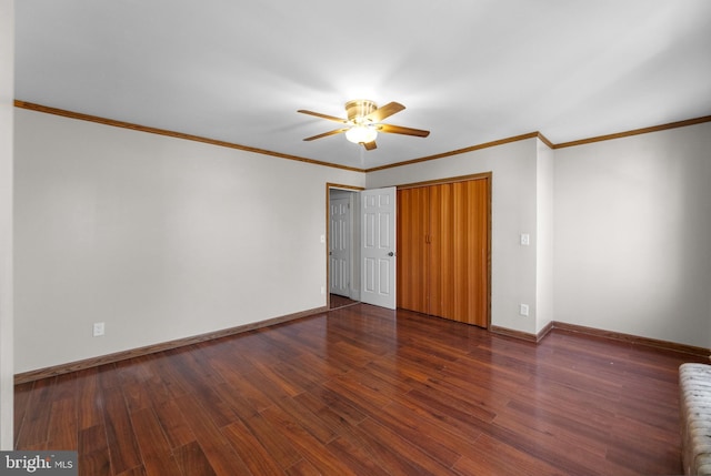 unfurnished room featuring a ceiling fan, crown molding, baseboards, and wood finished floors