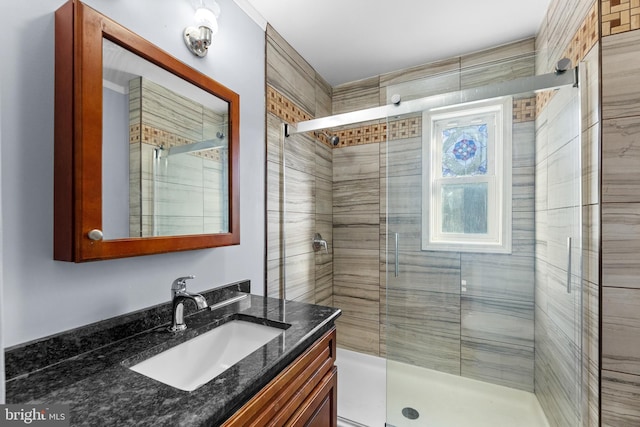 full bathroom featuring a stall shower and vanity