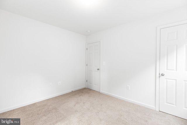 carpeted spare room with baseboards