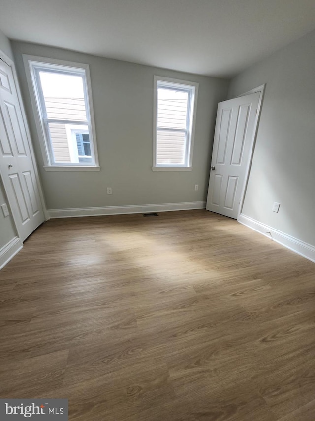 203 S Loudon Ave, Baltimore, MD 21229 - unfurnished bedroom with baseboards and wood finished floors