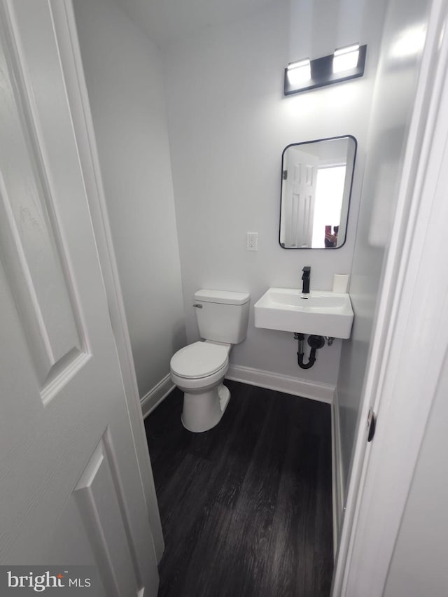203 S Loudon Ave, Baltimore, MD 21229 - half bath with wood finished floors, baseboards, toilet, and a sink