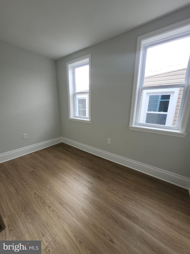 203 S Loudon Ave, Baltimore, MD 21229 - spare room featuring baseboards and dark wood finished floors