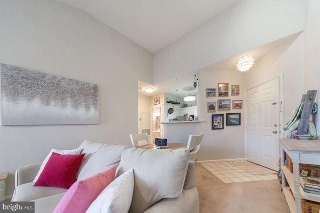 living room with carpet floors, baseboards, high vaulted ceiling, and tile patterned floors