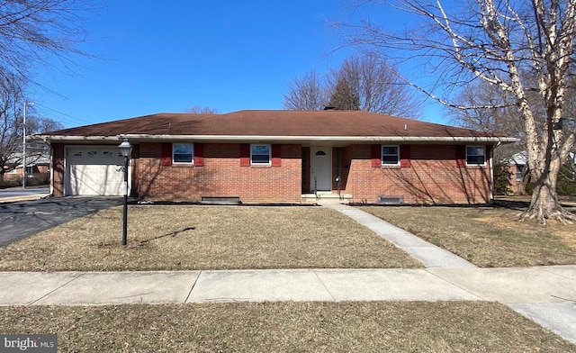 single story home with a garage, brick siding, and aphalt driveway