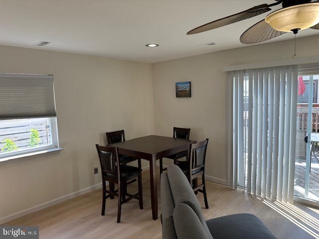 dining space with light wood finished floors, recessed lighting, a ceiling fan, and baseboards