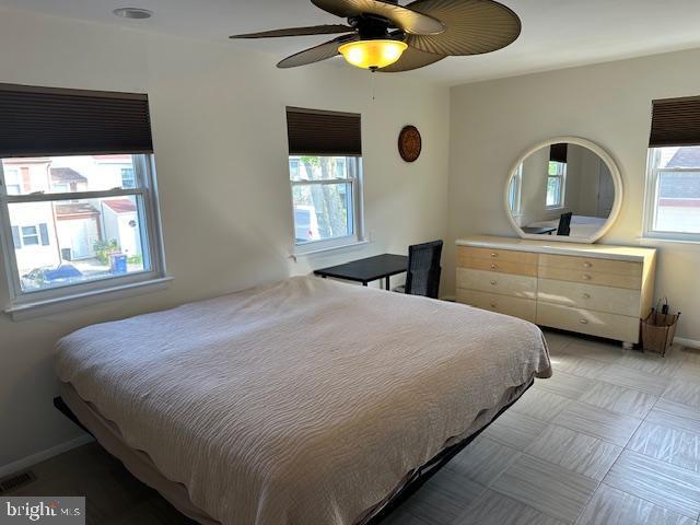 bedroom featuring baseboards, visible vents, and a ceiling fan