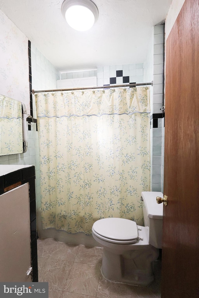 full bathroom with shower / bathtub combination with curtain, toilet, and wallpapered walls