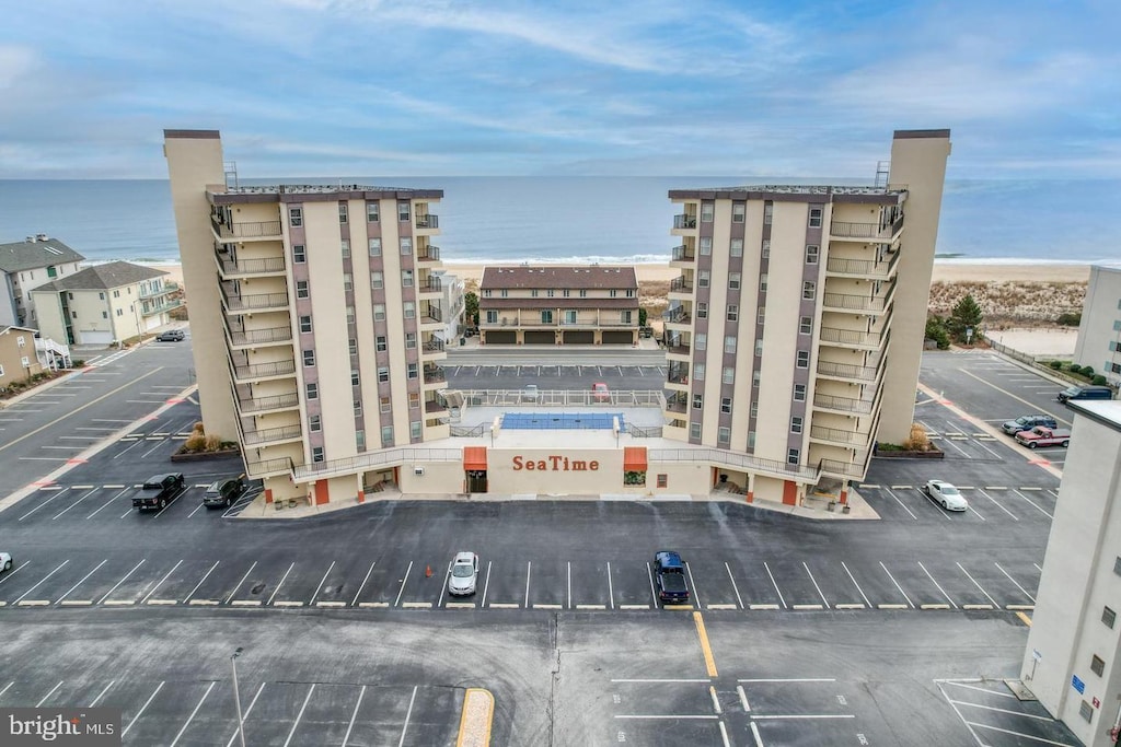 view of property with a water view and uncovered parking