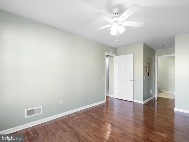 interior space featuring visible vents, ceiling fan, baseboards, and wood finished floors