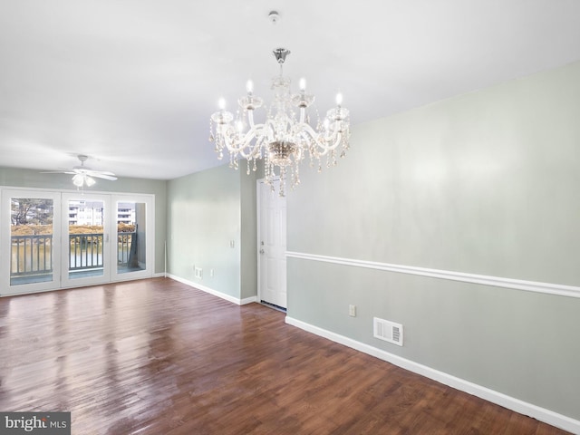 interior space featuring baseboards, visible vents, wood finished floors, and ceiling fan with notable chandelier