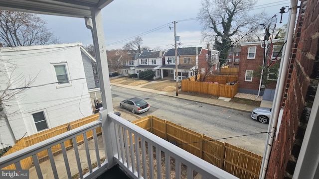 balcony featuring covered porch and a residential view