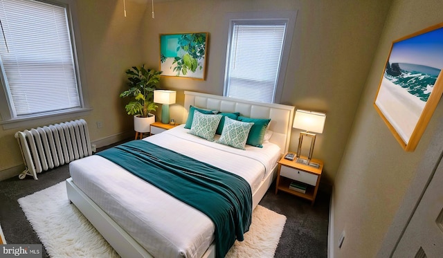 carpeted bedroom featuring baseboards, multiple windows, and radiator heating unit