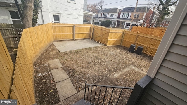 view of yard with a fenced backyard and a residential view