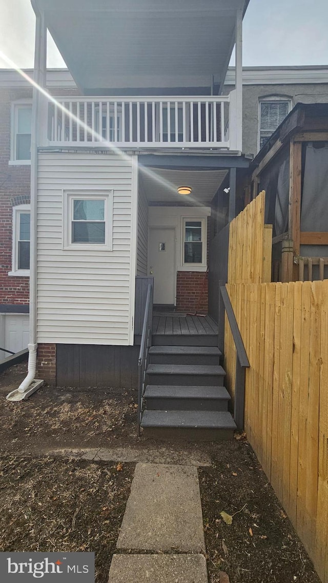 entrance to property with a balcony