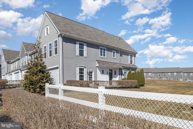 view of front of home featuring a garage and fence