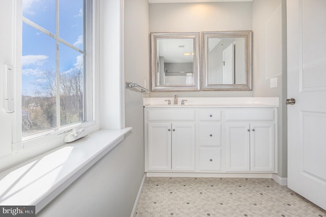 bathroom with vanity, tile patterned floors, and baseboards