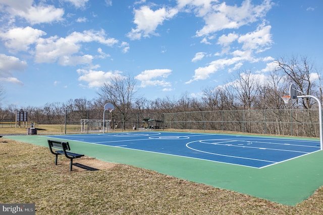 view of basketball court featuring community basketball court, a lawn, and fence