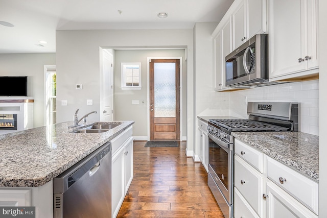 kitchen featuring a sink, white cabinetry, hardwood / wood-style floors, and stainless steel appliances