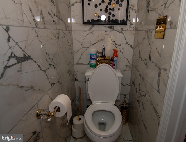 bathroom with stone wall and toilet