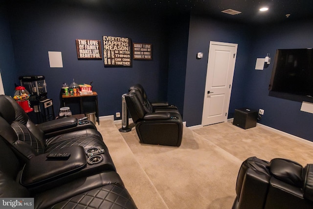 carpeted cinema room featuring visible vents and baseboards