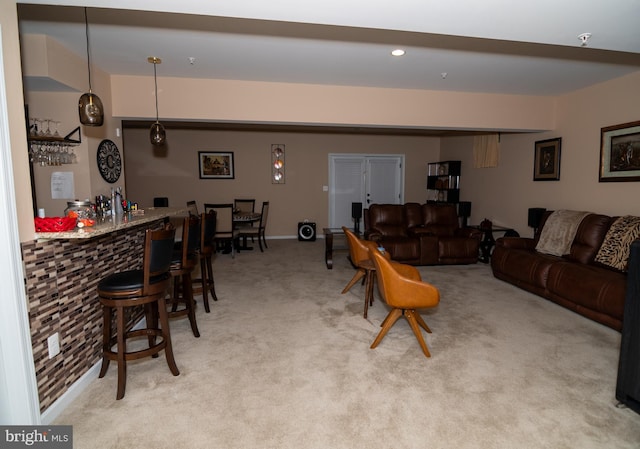 carpeted living room featuring a dry bar