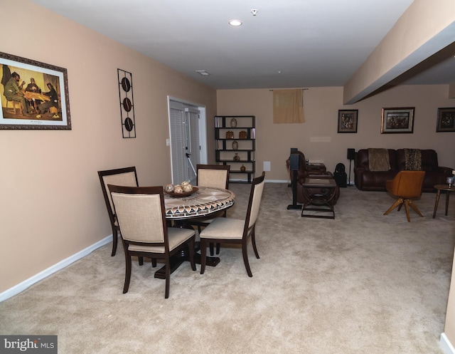 dining space with recessed lighting, light carpet, and baseboards