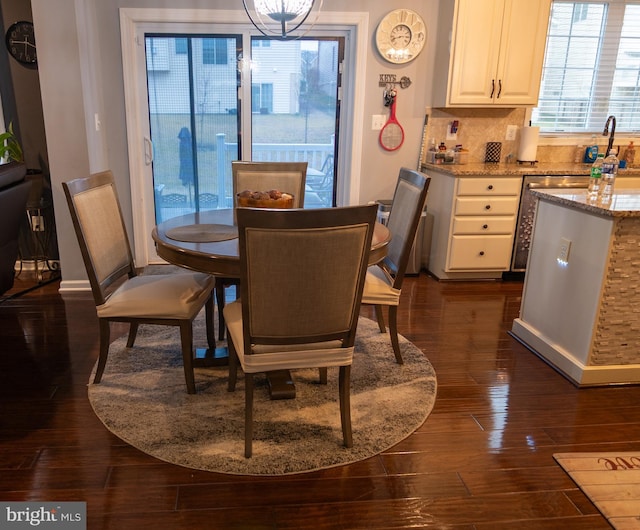 dining space featuring baseboards and dark wood-style flooring