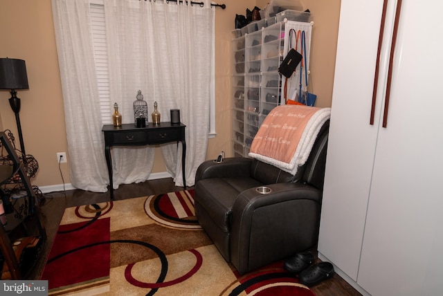 sitting room featuring baseboards and wood finished floors