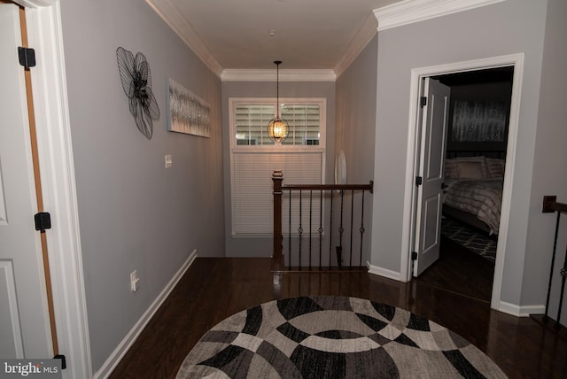 hallway with crown molding, an upstairs landing, and wood finished floors